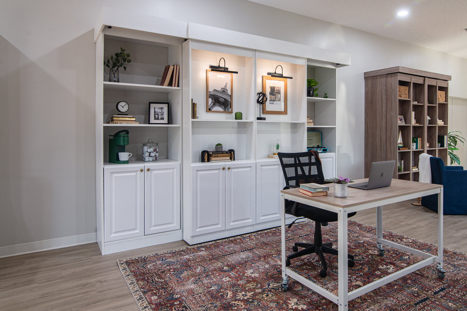Murphy Bed Depot showroom photo of the Majestic Library Bed: Supreme in the foreground and the Boaz Bifold Bookcase Bed in the background