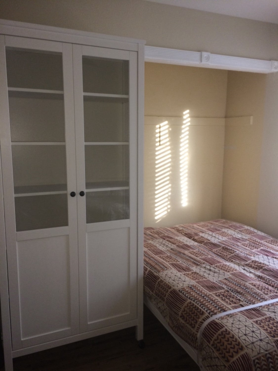 The Next Bed Wall-Mounted Murphy Bed Frame in color white in cabinet style, pulled down
